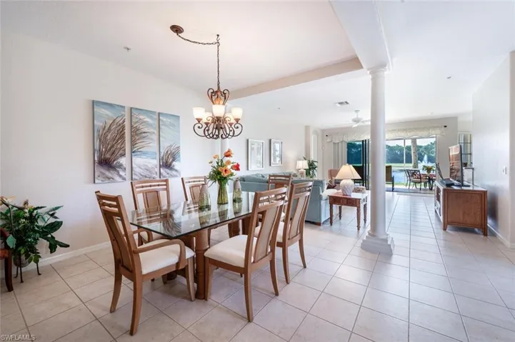 Dining area with decorative columns, light tile patterned flooring, and baseboards