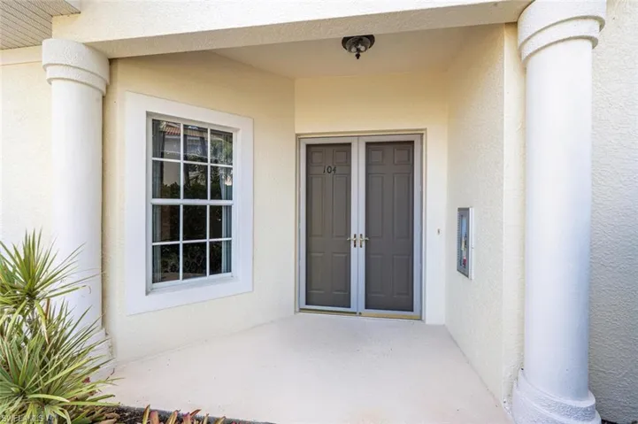 Entrance to property with stucco siding