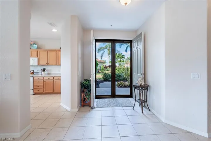 Entryway featuring baseboards and light tile patterned flooring