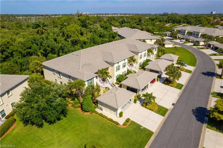This property features a well-maintained exterior with a tiled roof, lush green lawns, and mature trees