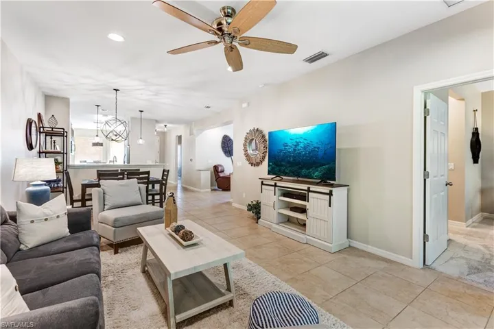 Expansive open concept living area featuring tile flooring, recessed lighting, and a ceiling fan