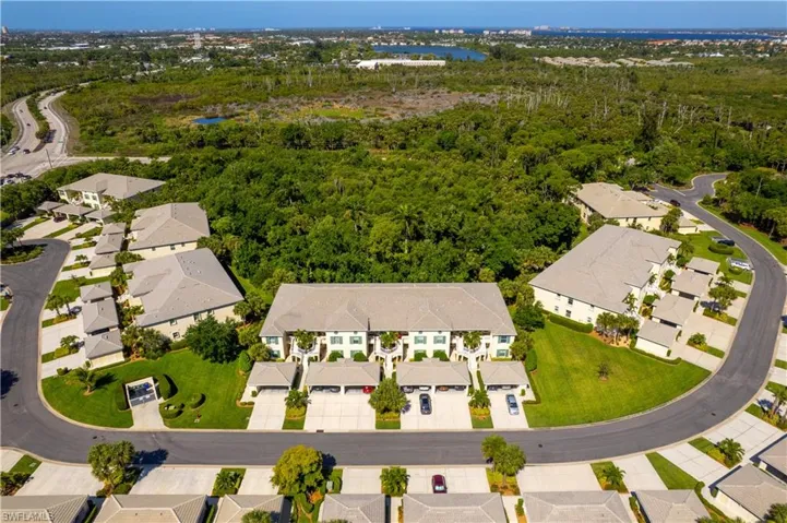This aerial view showcases a residential community with well-maintained grounds and mature landscaping
