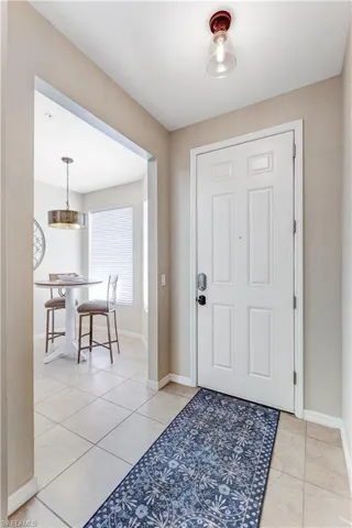 The property features a welcoming entry with light-colored tile flooring and a white paneled entry door