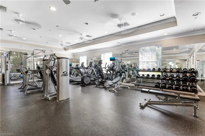The property includes a well-equipped fitness center with various exercise machines, free weights, and a cushioned floor