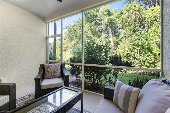 Screened patio with textured walls and a view of lush greenery