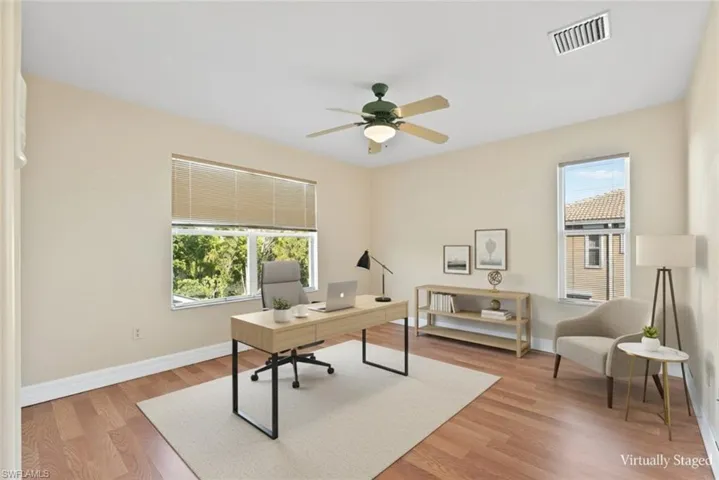 Home office with light wood finished floors and ceiling fan