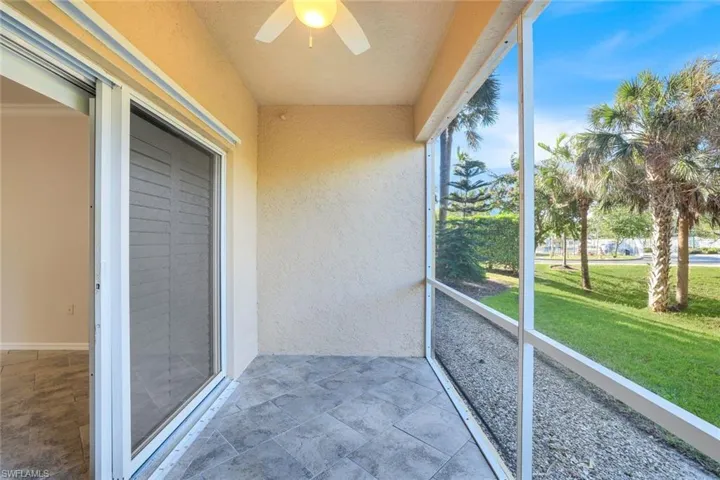 Unfurnished sunroom featuring ceiling fan