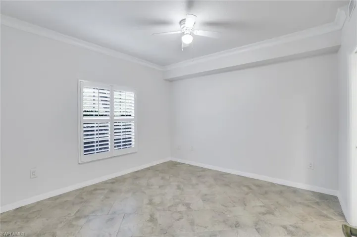 Unfurnished room featuring crown molding and ceiling fan