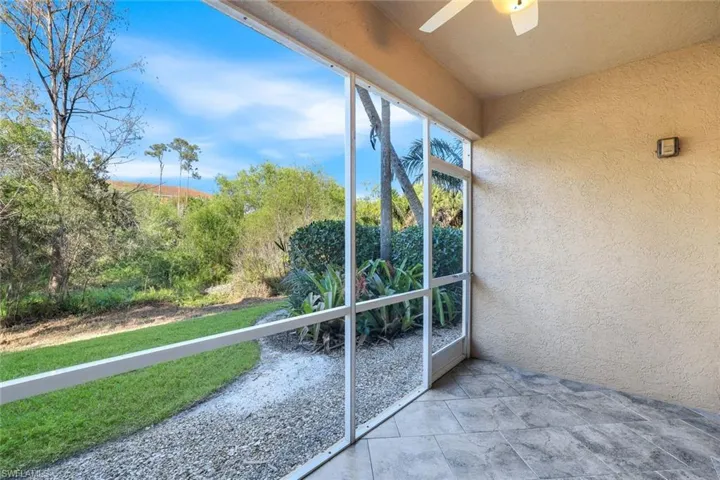 Unfurnished sunroom with ceiling fan