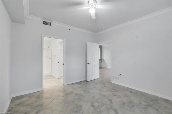 Unfurnished bedroom with crown molding and ceiling fan