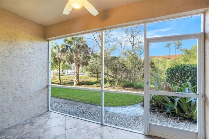 Unfurnished sunroom with ceiling fan