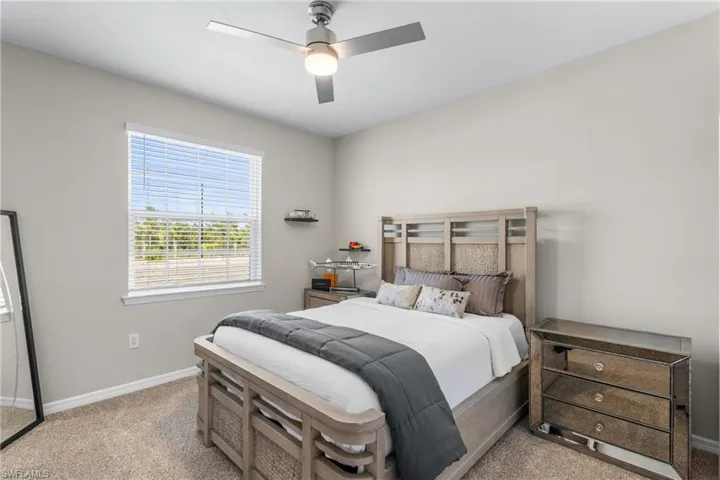 Bedroom featuring ceiling fan and light colored carpet