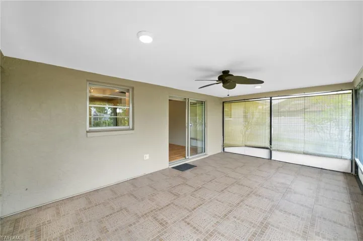 Carpeted empty room with plenty of natural light and ceiling fan