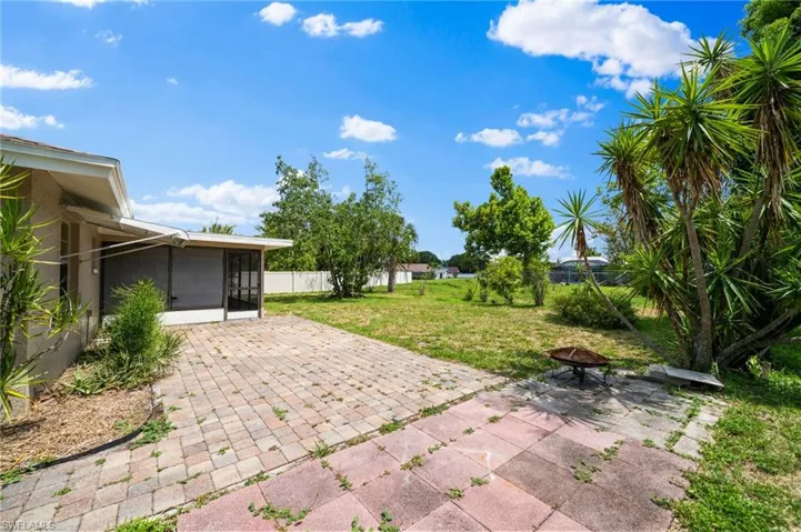 View of terrace with a sunroom and a fire pit