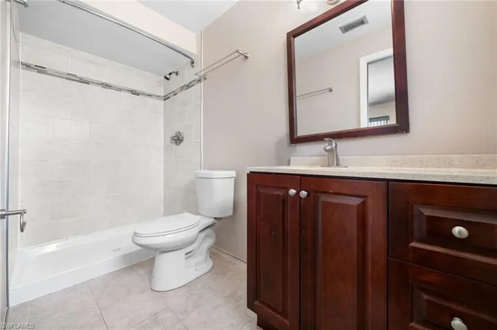 Bathroom featuring tile flooring, vanity, and toilet
