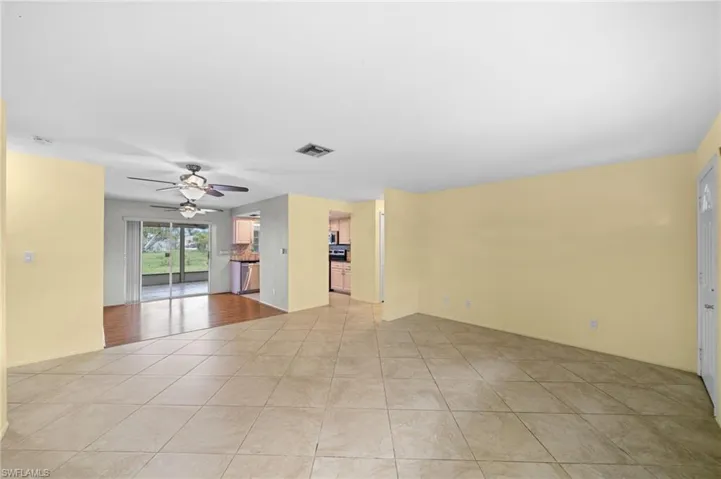 Tiled spare room with ceiling fan