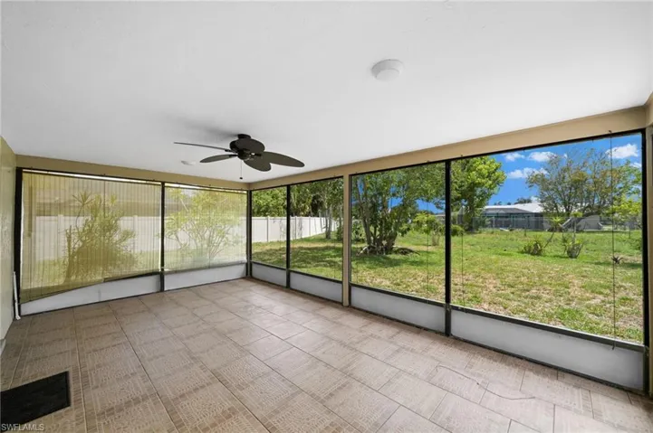 Unfurnished sunroom featuring ceiling fan