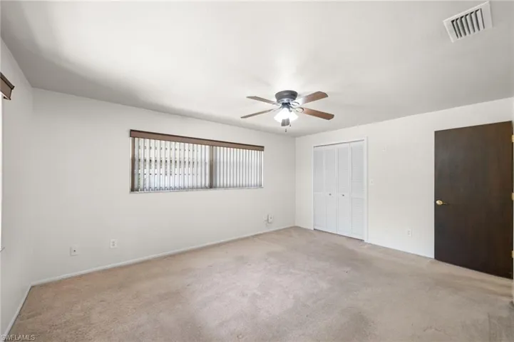 Spare room featuring ceiling fan and carpet floors