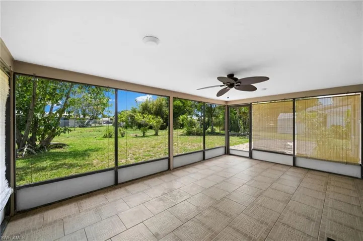 Unfurnished sunroom with ceiling fan