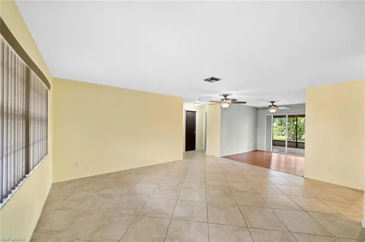 Tiled empty room with ceiling fan