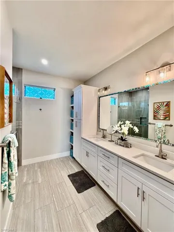 Bathroom with a stall shower and double vanity