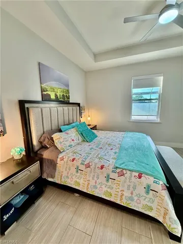 Bedroom featuring multiple windows and a ceiling fan