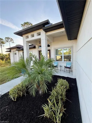 Entrance to property with a patio and stucco siding