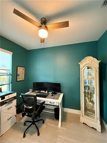 Office with baseboards and a ceiling fan