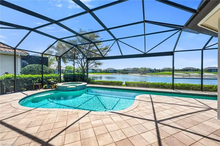 Integrated pool / spa with a sunroom, a water view, and a lanai