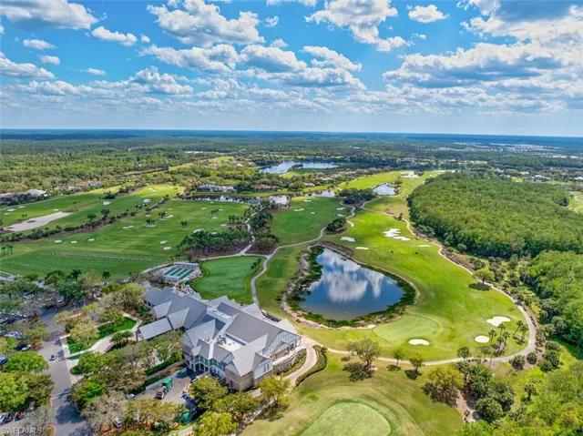 Aerial view of property's location with a local golf course and a nearby body of water