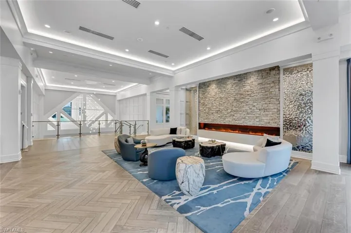 Common area with a raised ceiling and recessed lighting