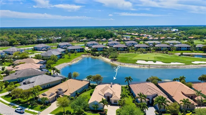 Aerial perspective of suburban area with a large body of water and a local golf course