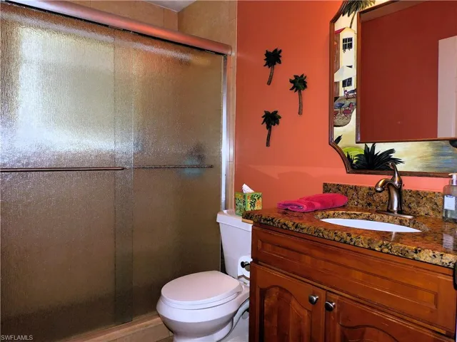 Full bathroom with vanity and a stall shower