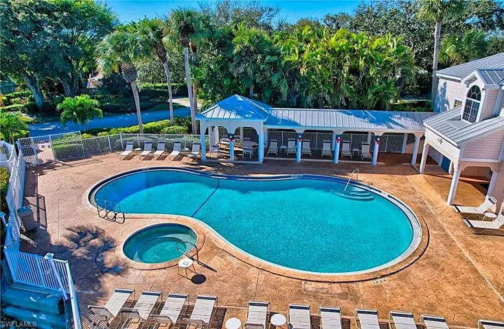 Community pool featuring a hot tub and a patio area