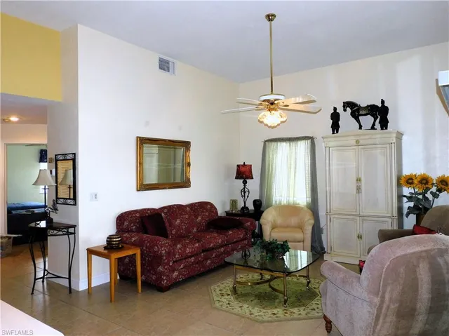 Tiled living room featuring ceiling fan