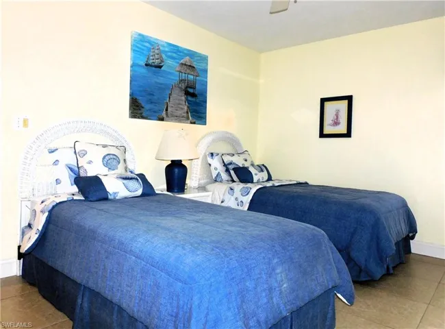 Bedroom with tile patterned floors and a ceiling fan
