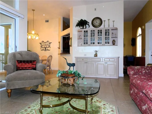 Living room with a chandelier and light tile patterned floors