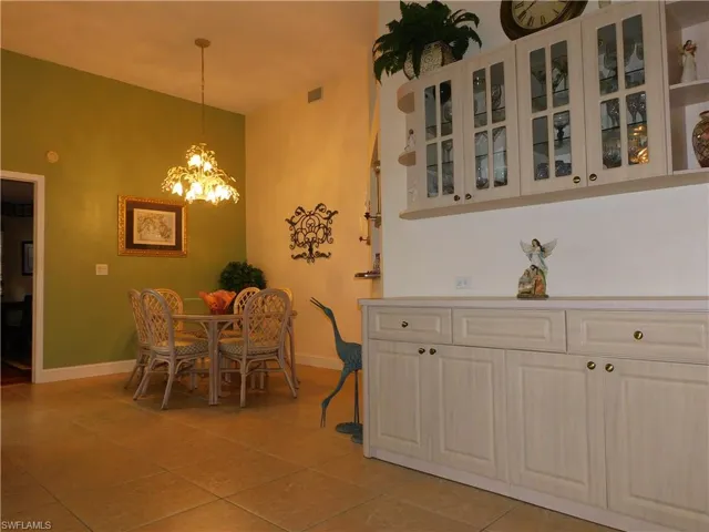 Dining room with a chandelier and light tile patterned floors