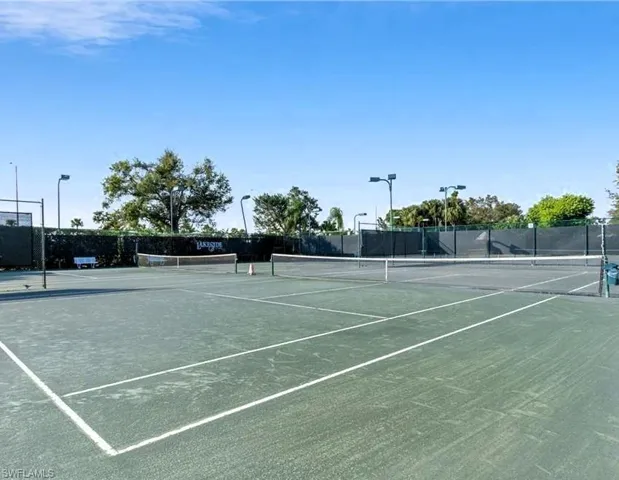 View of tennis court featuring community basketball court