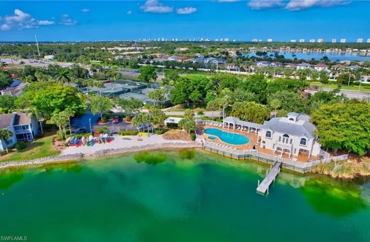 Aerial view of property's location with a large body of water and city skyline