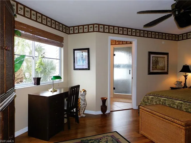 Bedroom featuring multiple windows, dark wood finished floors, and ceiling fan