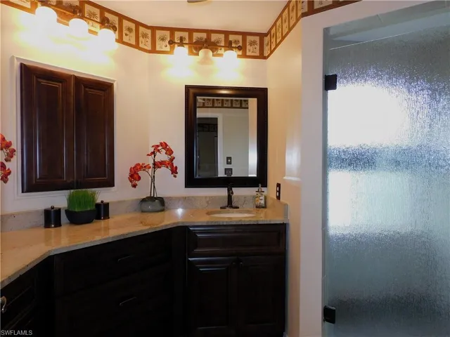 Full bath featuring vanity and a shower stall