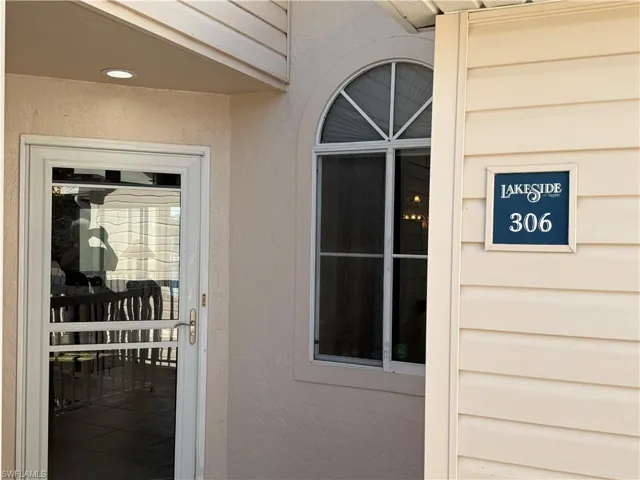Entrance to property with stucco siding
