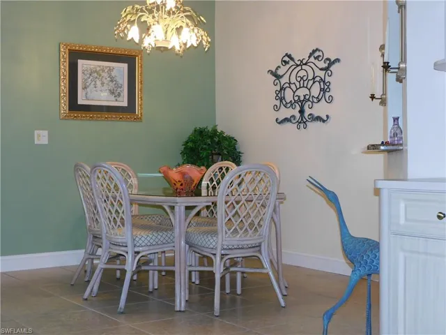 Dining room featuring a chandelier and dark tile patterned flooring
