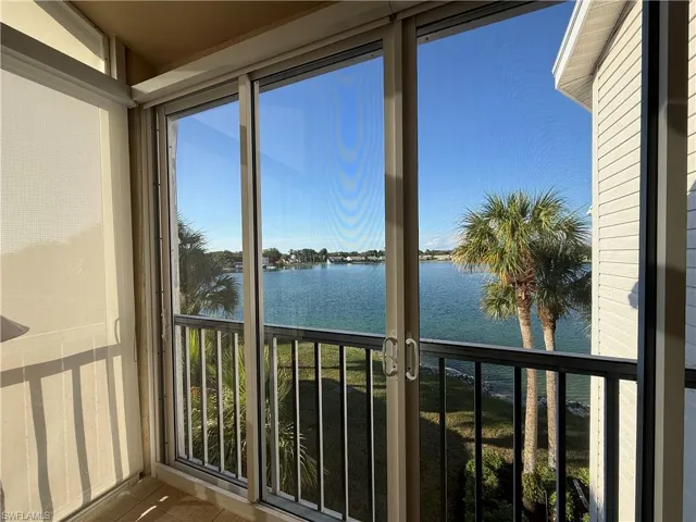 Unfurnished sunroom featuring a water view