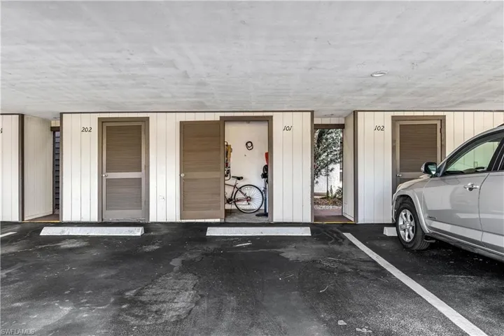 Assigned covered carport parking area with additional unit storage for bikes and beach gear.