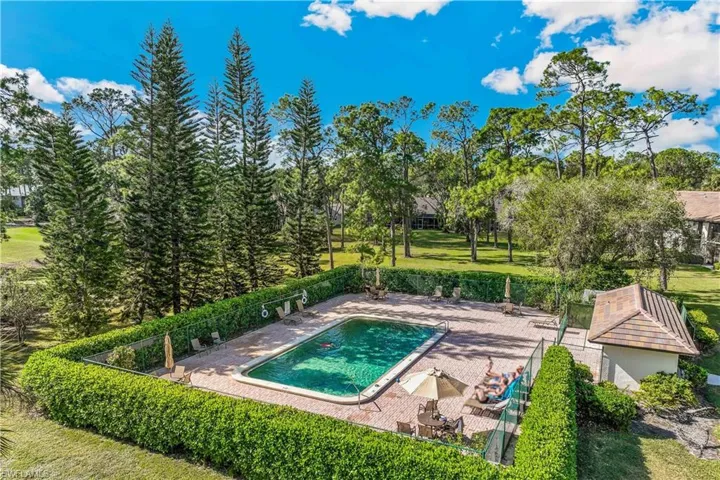 View of community swimming pool featuring a patio area