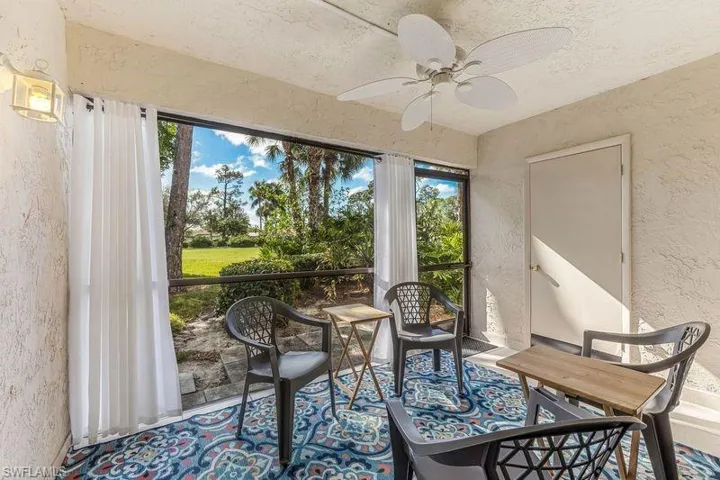 Screened lanai featuring ceiling fan, storage area, and amazing view of the golf course