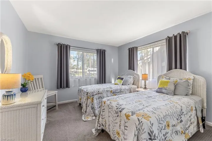 View of guest bedroom with newer carpet and twin beds
