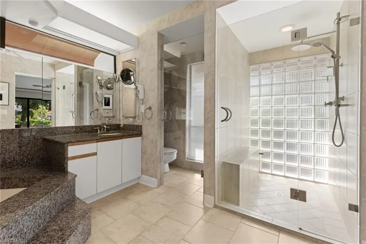 Bathroom with enclosed toilet and walk in shower
